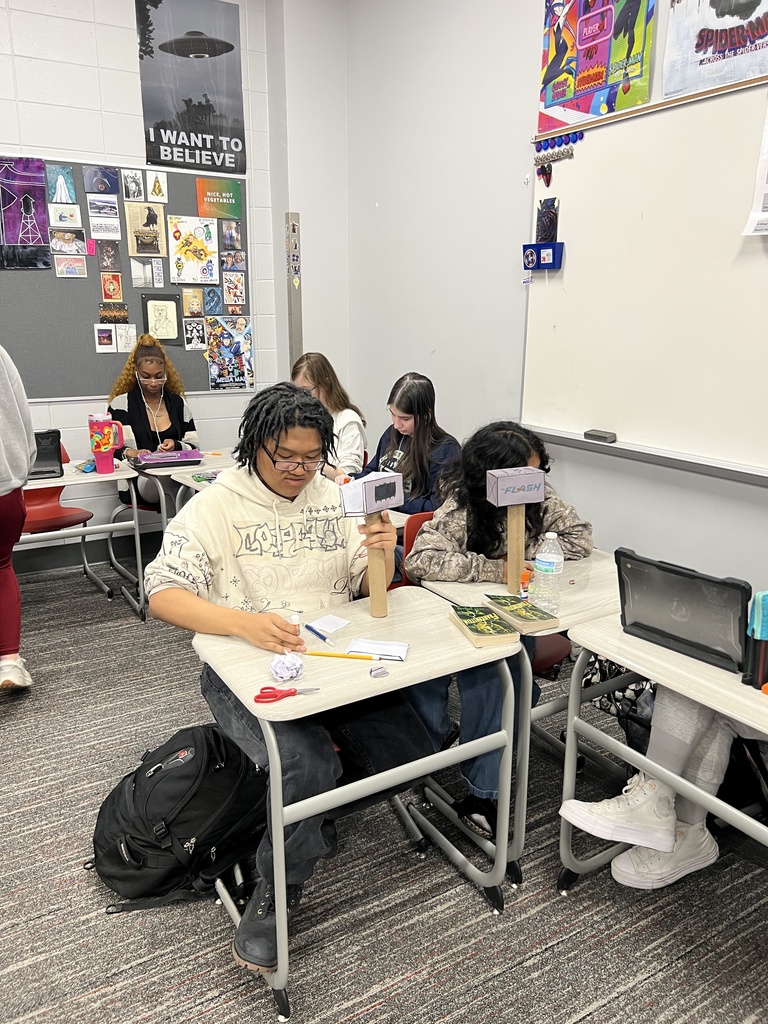 Students building hammers out of cardboard tubes and paper