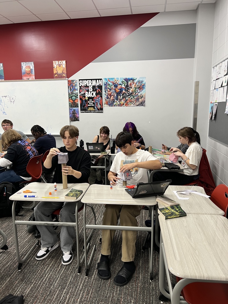 Students building hammers out of cardboard tubes and paper
