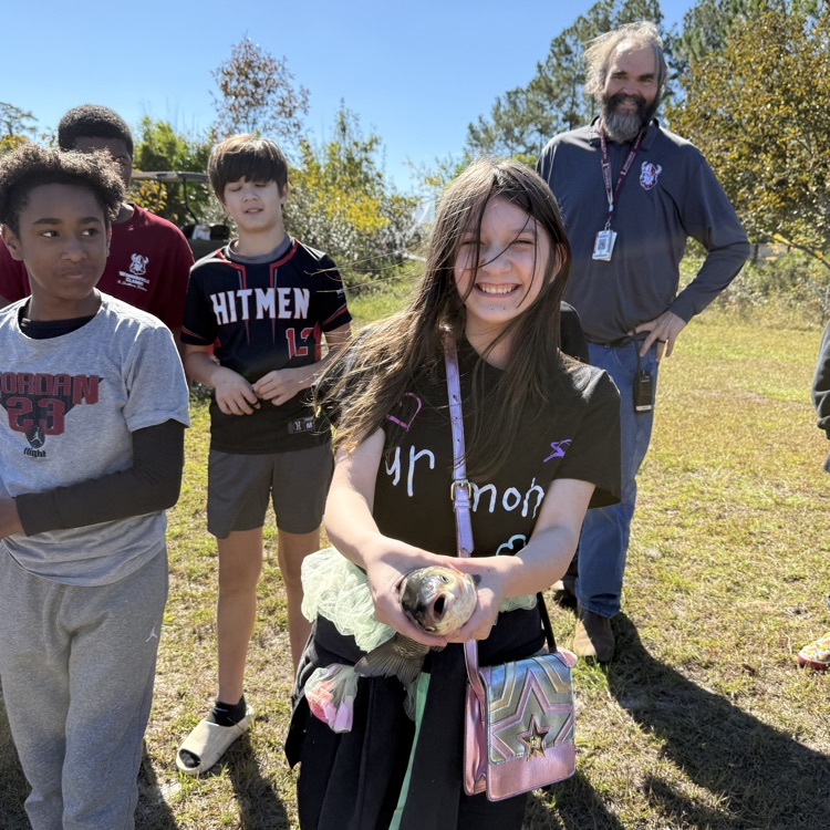 student holding fish 