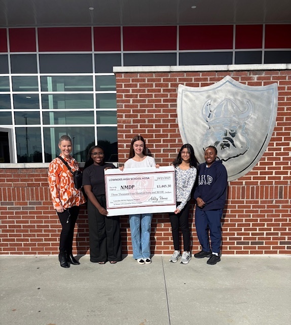 Mrs. Cooper with HOSA members and a check to NMDP