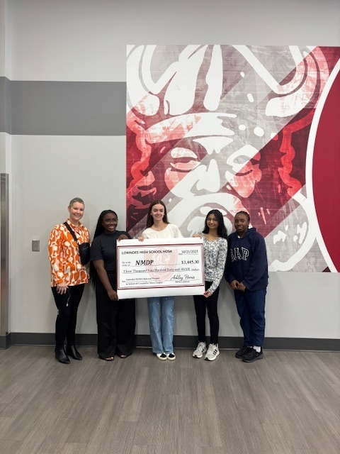 Mrs. Cooper with HOSA members and a check to NMDP