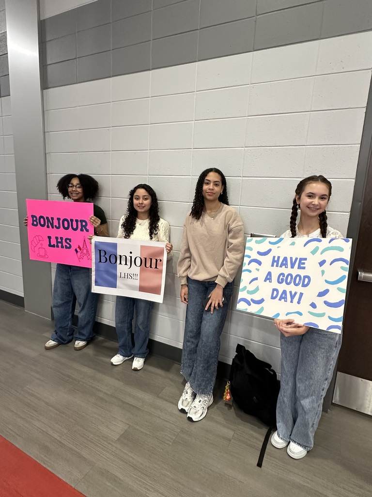 Students with Welcome signs in French