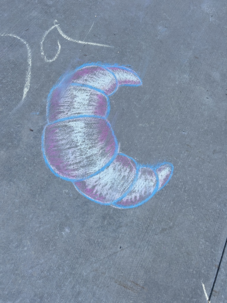 Sidewalk chalk picture of a croissant