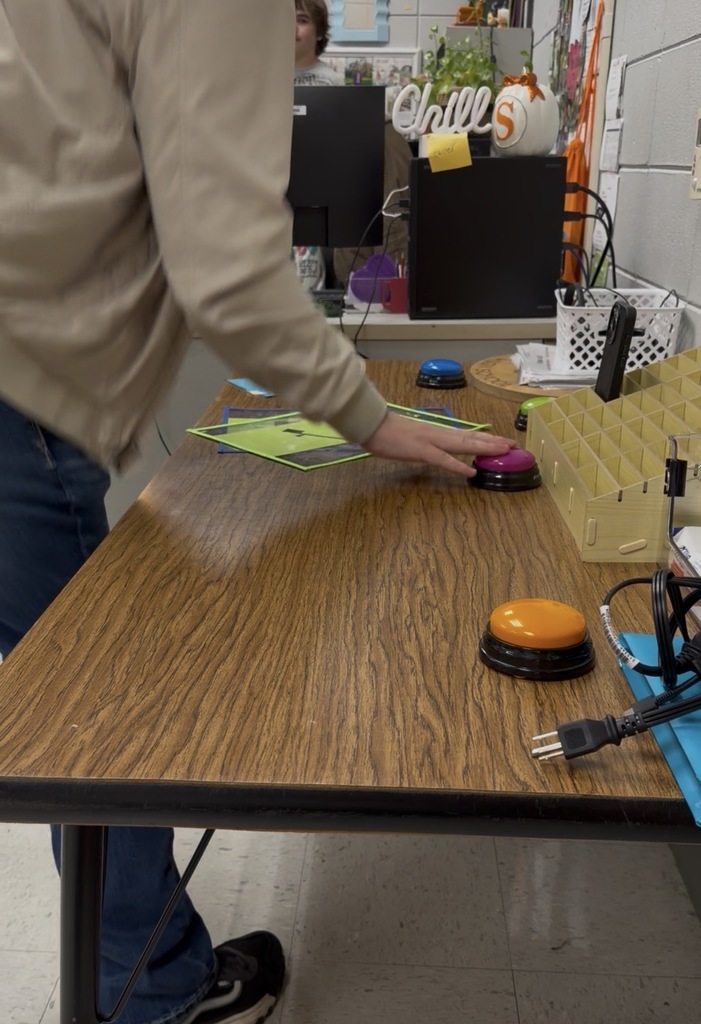 Student pressing a buzzer