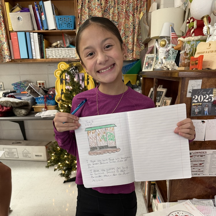 student holding stem journal 