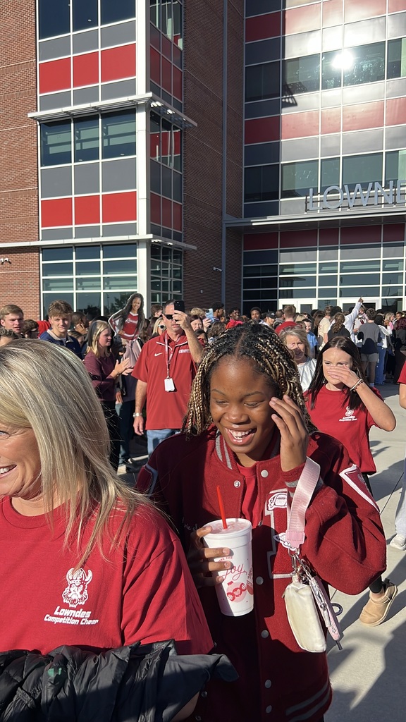 Cheerleaders walking through supporters to the bus