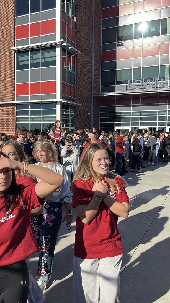 Cheerleaders walking through supporters to the bus