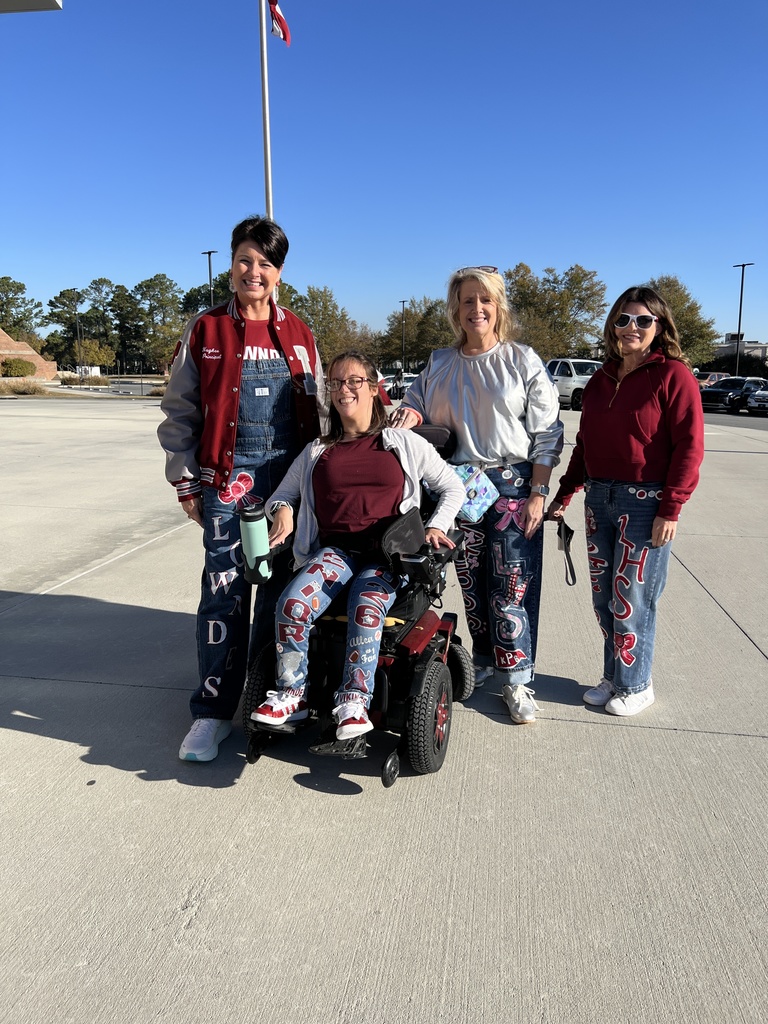 Three admin and a student in painted Viking spirit jeans.