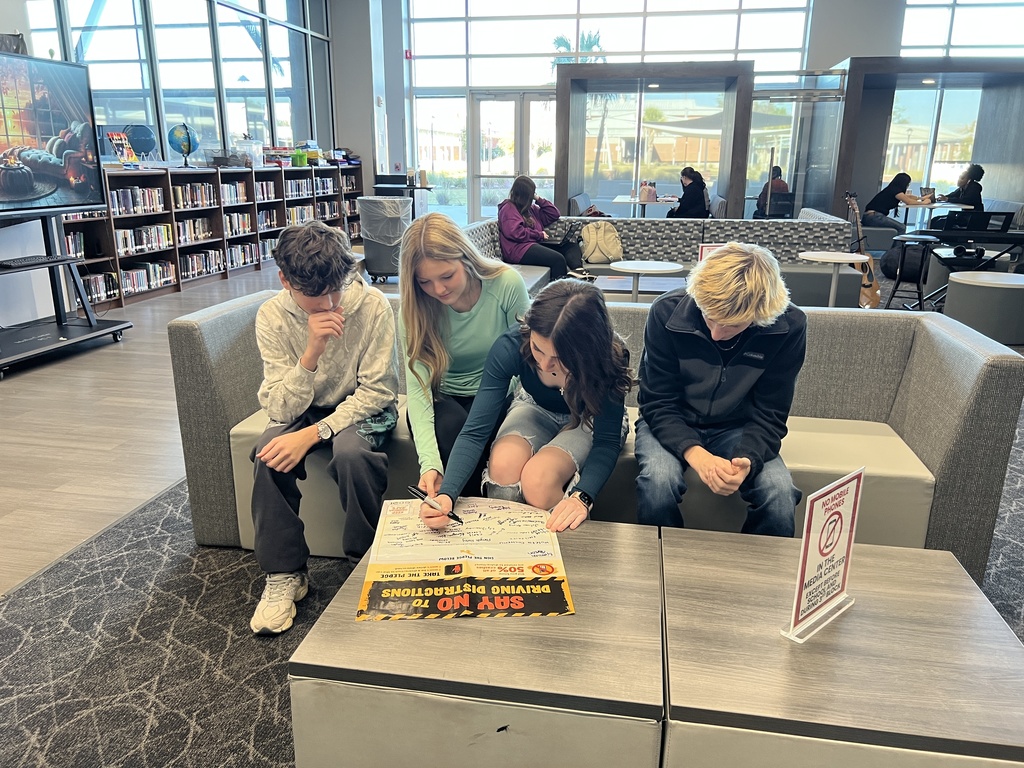 Students signing the pledge poster