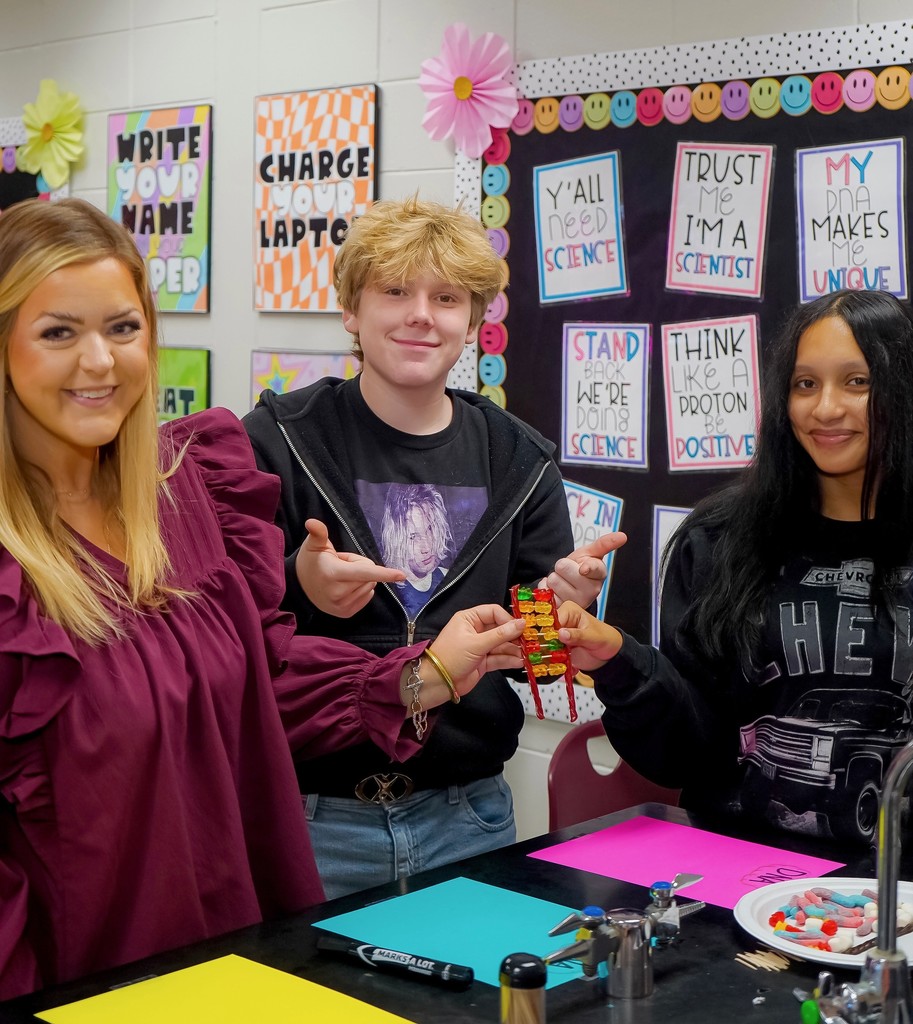 Teacher with students showing model