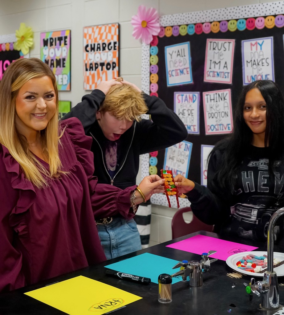 Teacher with students showing model