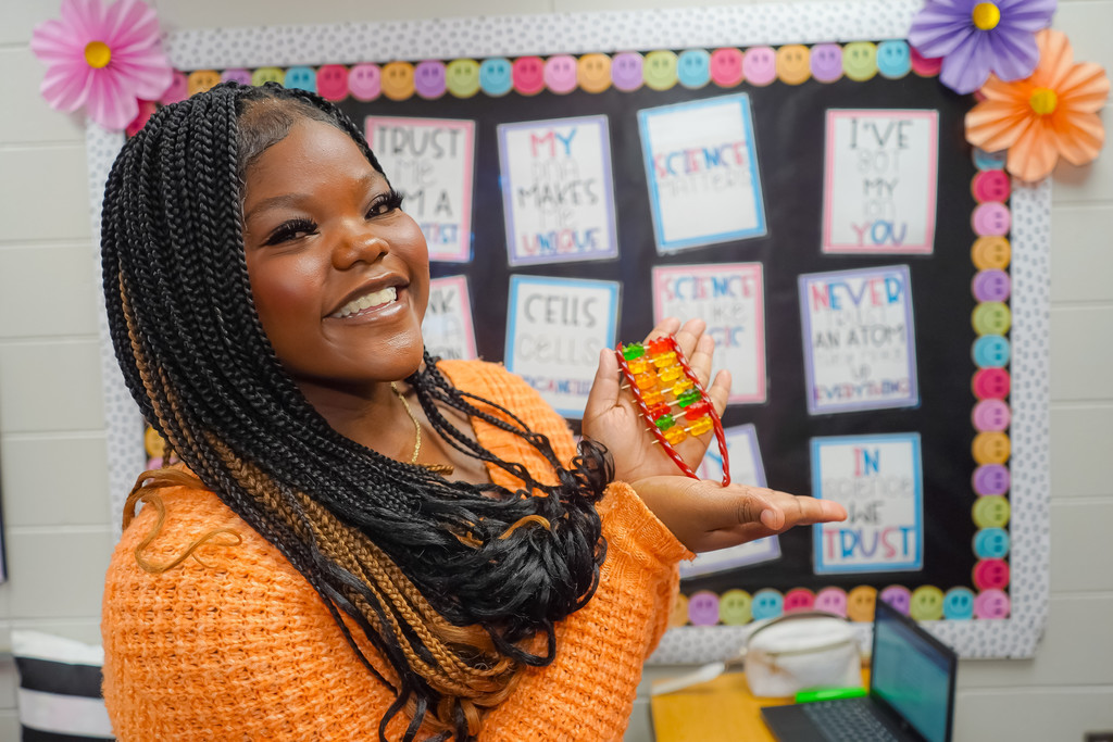 Student displaying her DNA model