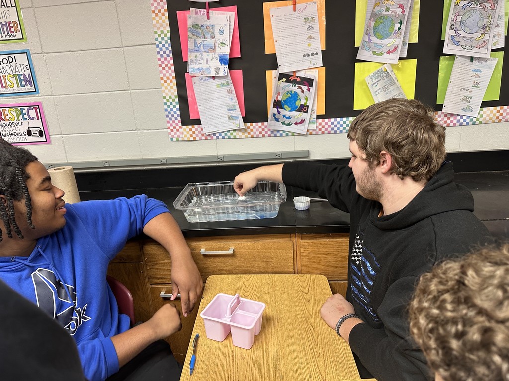 Students working an oil spill experiment