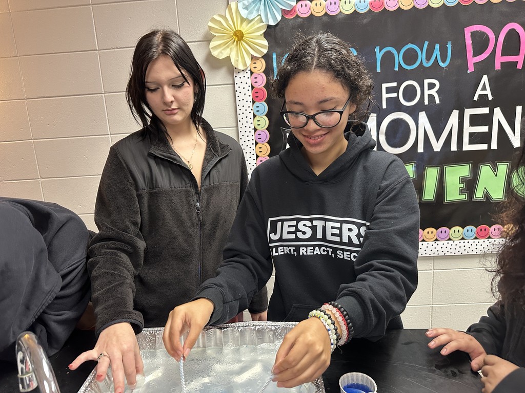 Students working an oil spill experiment