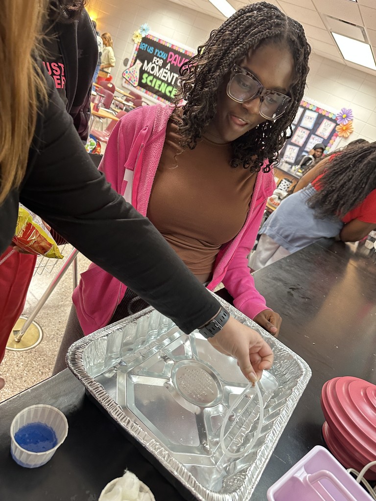 Students working an oil spill experiment