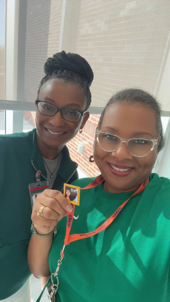 2 adults wearing green