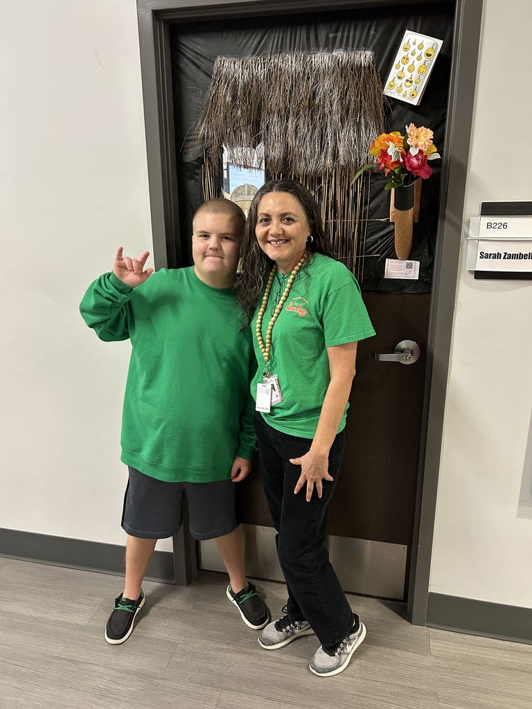 Teacher and student wearing green