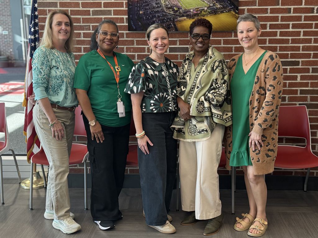 5 adults wearing green