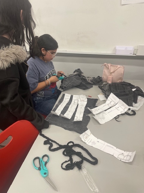 Student cutting denim