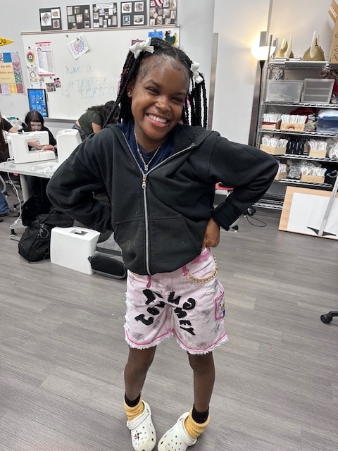 Student modeling upcycled denim shorts