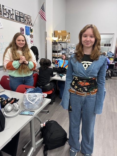 Student modeling a shirt made from denim