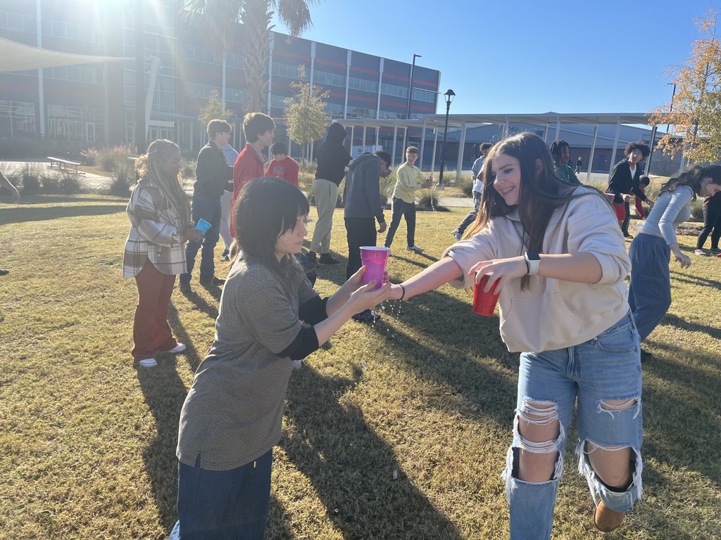 Students playing a relay game with cups