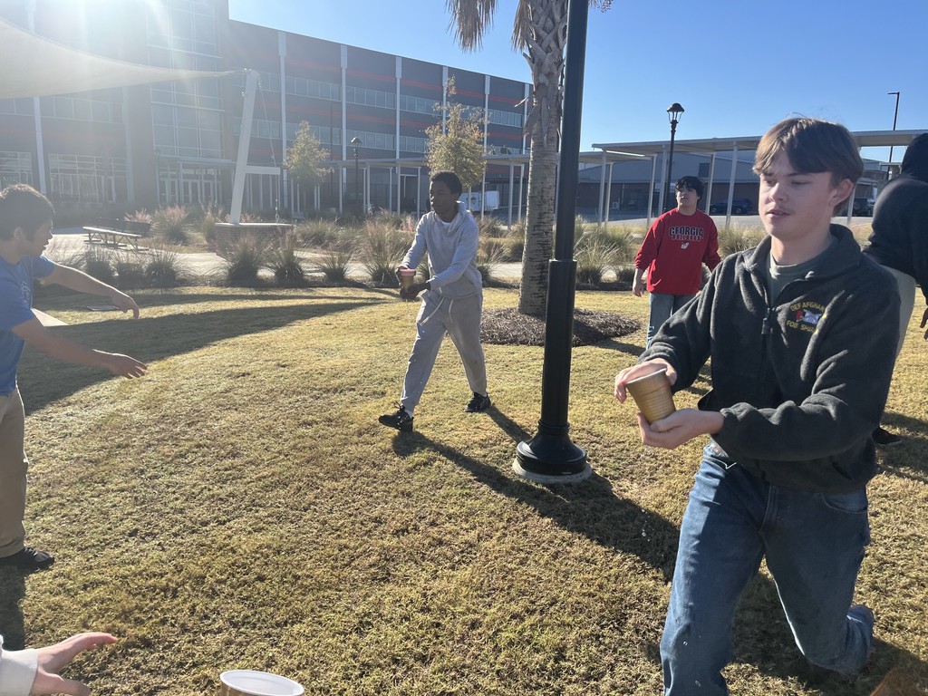Students playing a relay game with cups