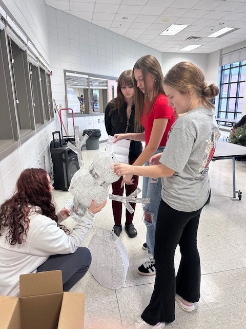 Students putting together props for the room