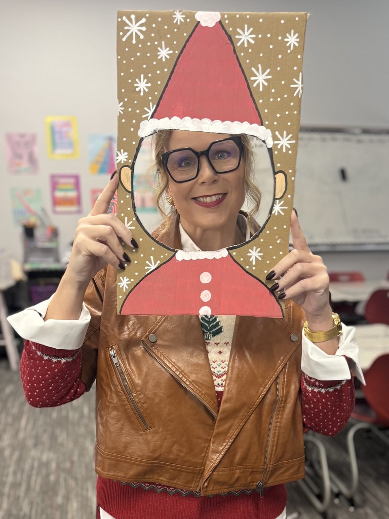 Teacher taking a selfie with an elf cutout