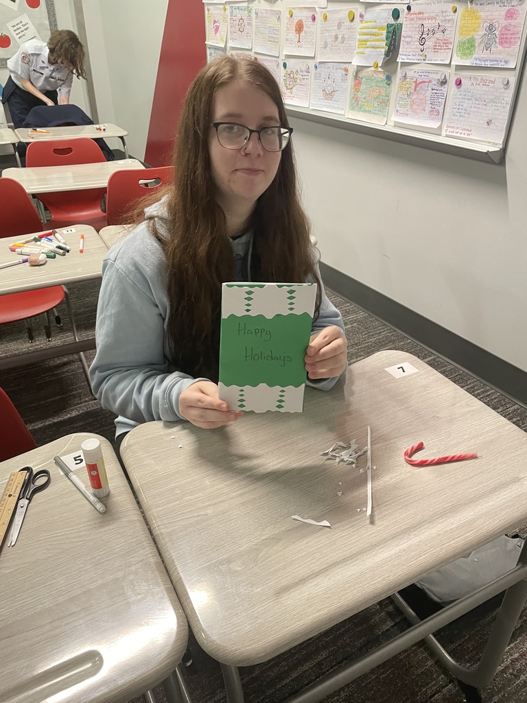 Student showing her card that she made