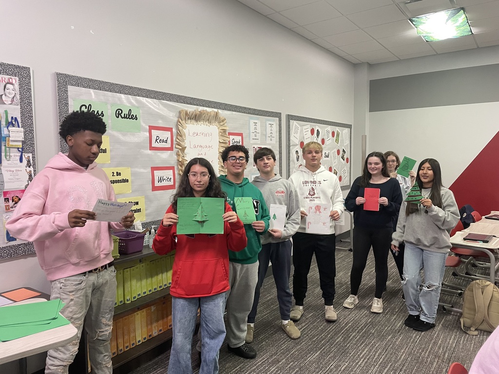 Students showing the cards they made