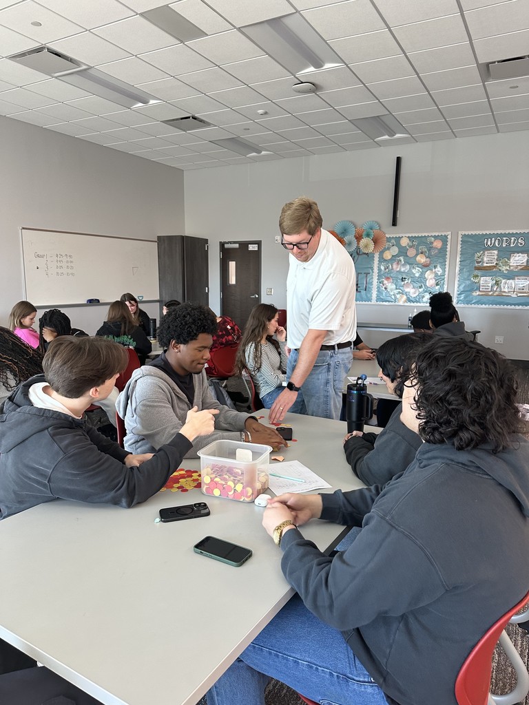 Coach Teehee checking in on a group of students