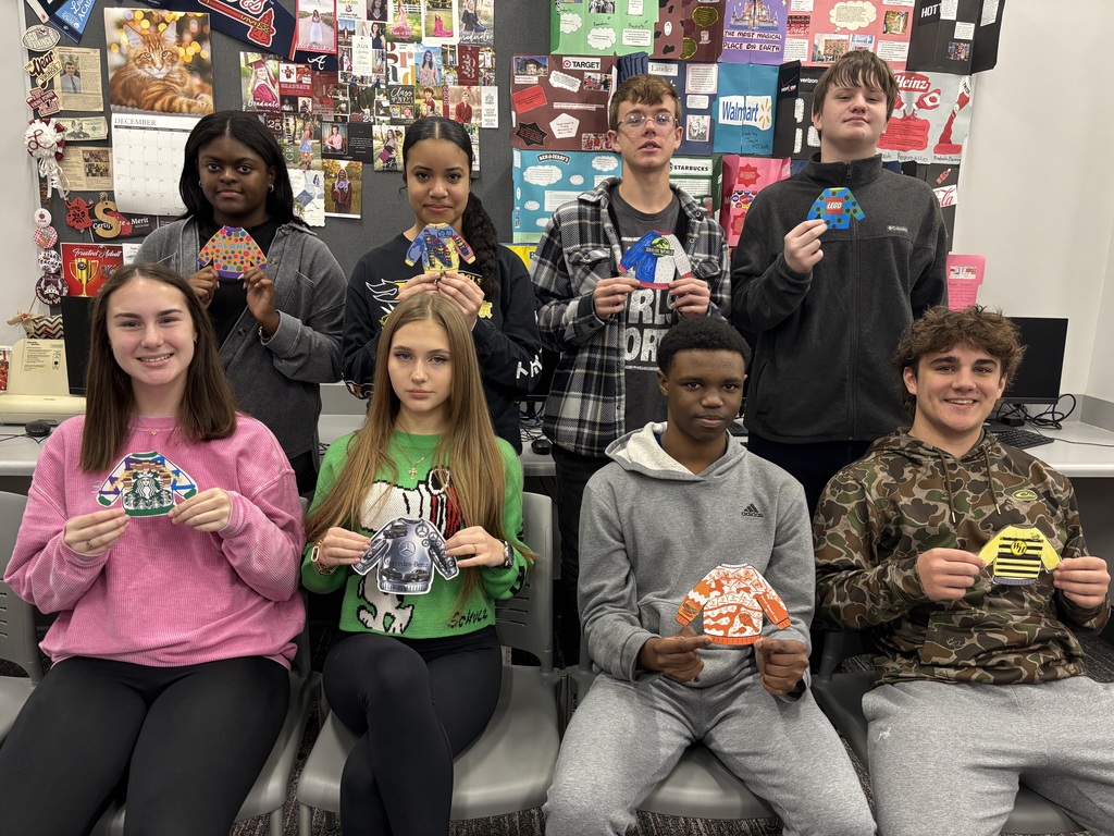 Students holding their ugly sweater mock ups