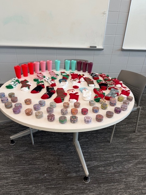 Table with items for purchase including socks, cups and trinket boxes