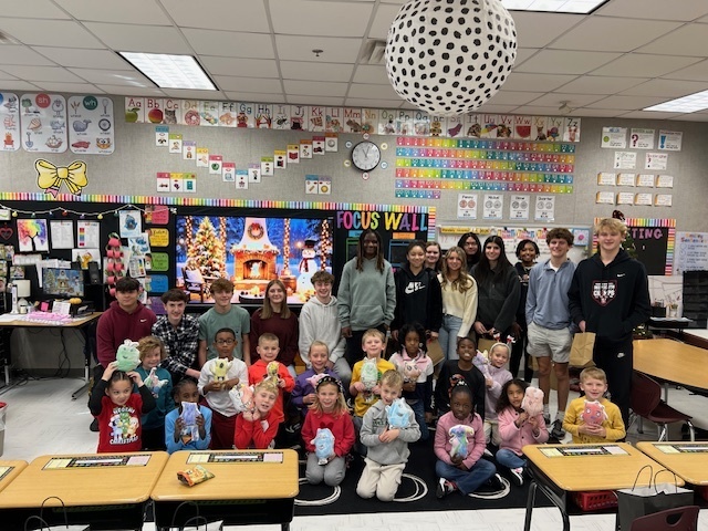 High school students with elementary students and their monsters