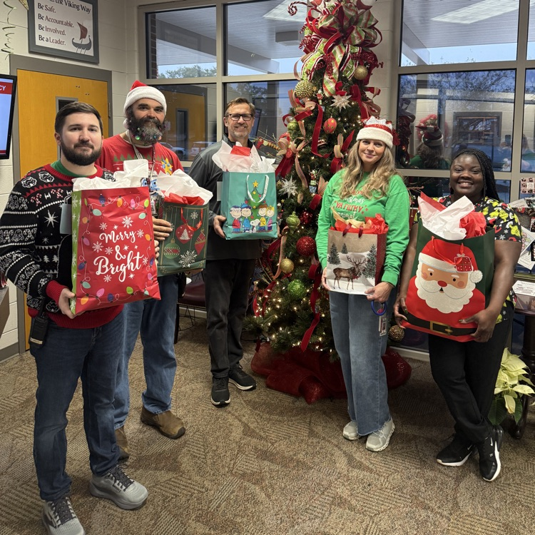 admin and counselors posing with gifts 