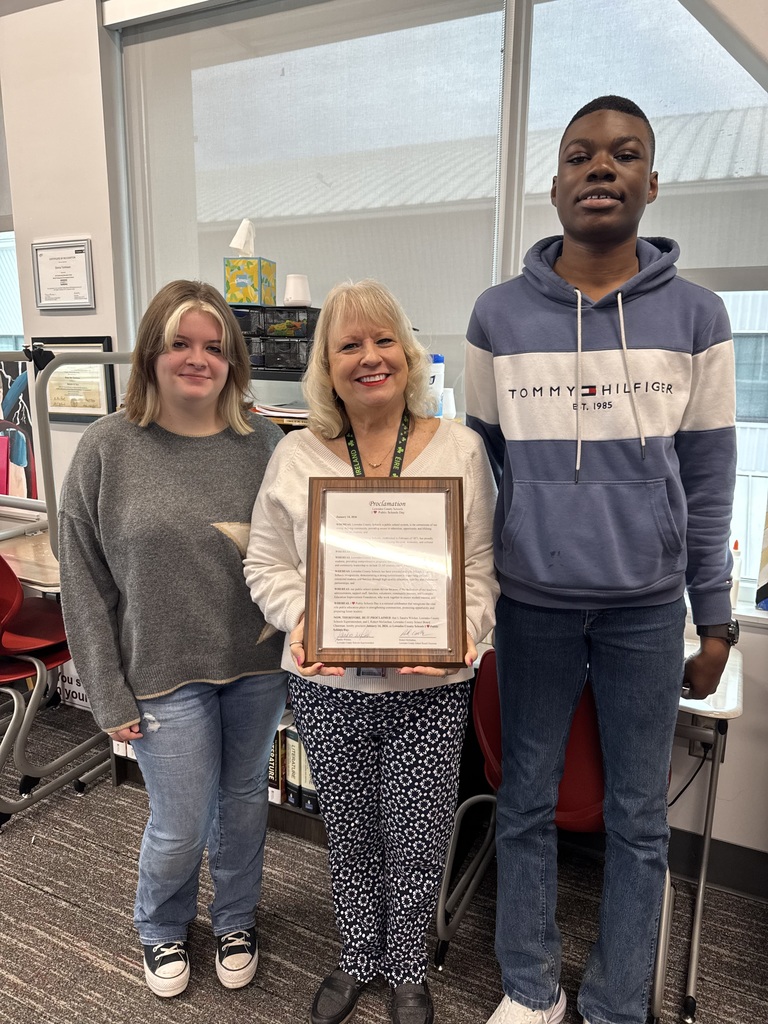 Teacher and 2 students with proclamation