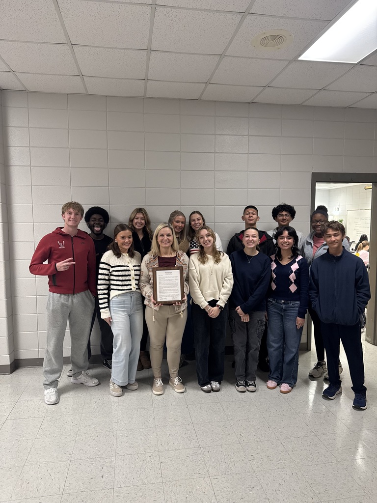 Teacher with large group of students and the proclamation