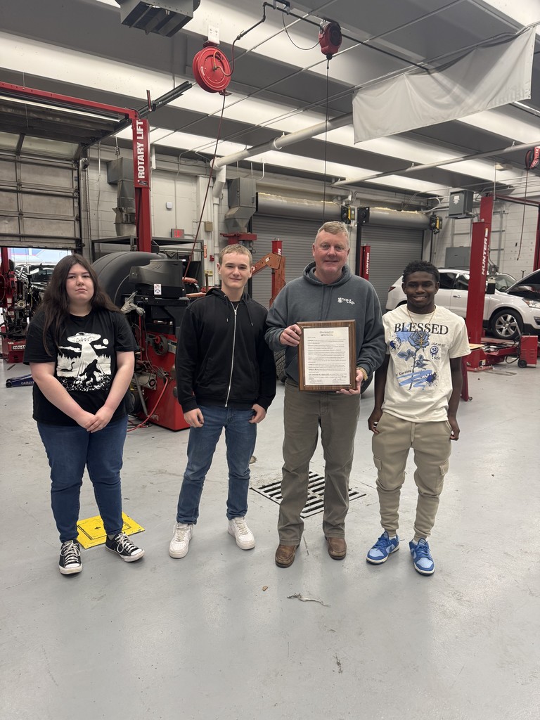 Teacher and students with proclamation