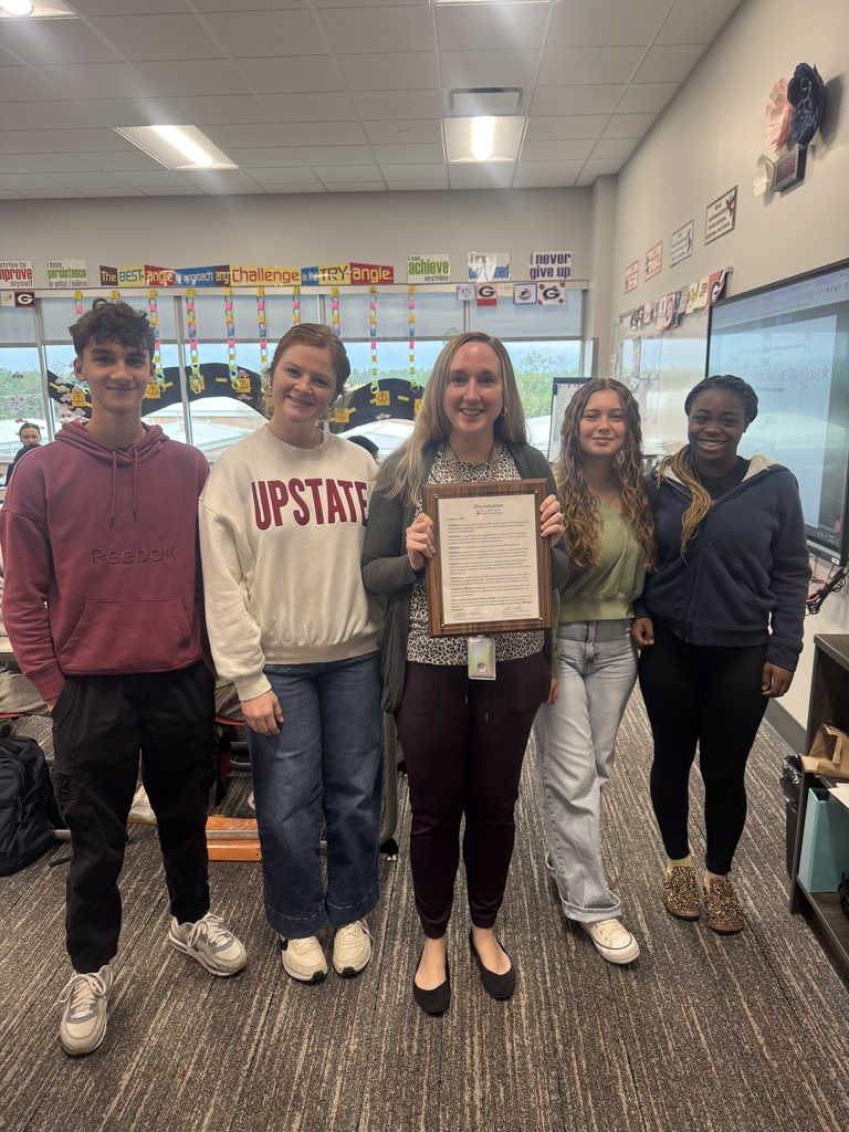 Teacher and students with proclamation