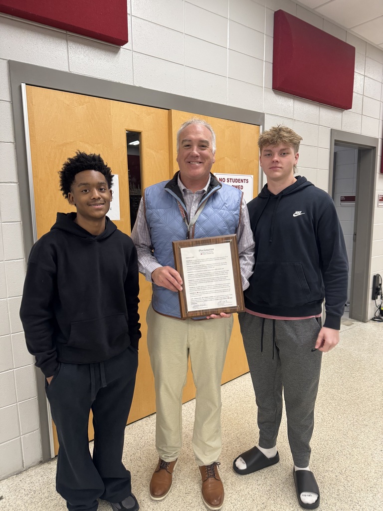 Band director and 2 students with proclamation