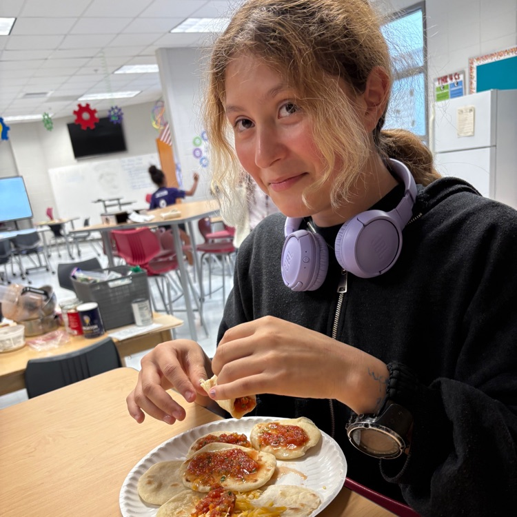 student enjoying food she made