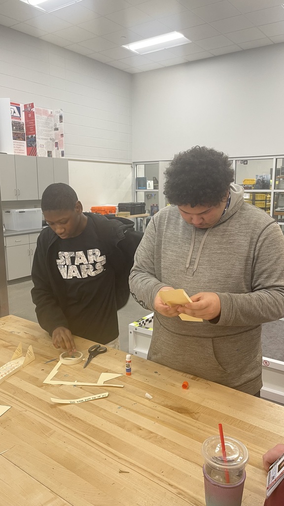 Students working together to builder gliders.