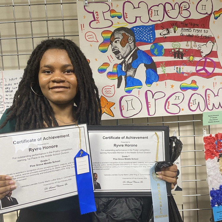 Ryvre posing with awards