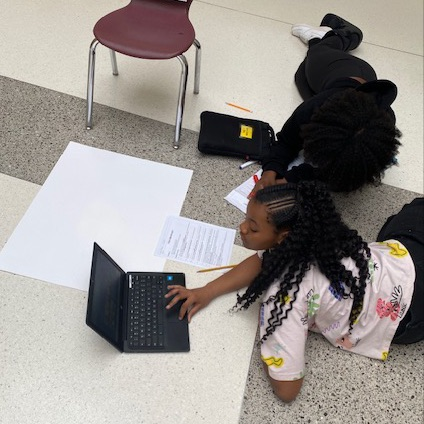 students working on food web posters