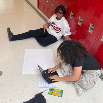 students working on food web posters