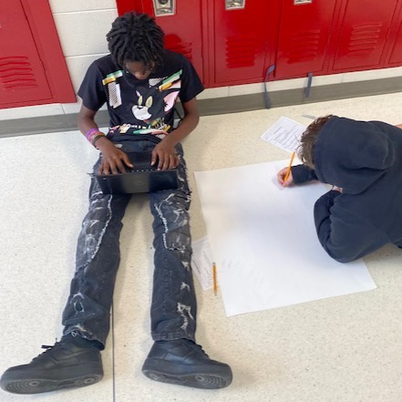 students working on food web posters