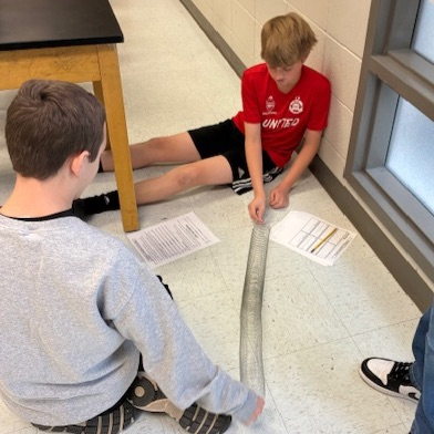 students playing with slinkies