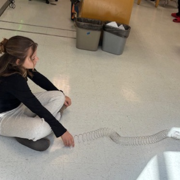 students playing with slinkies