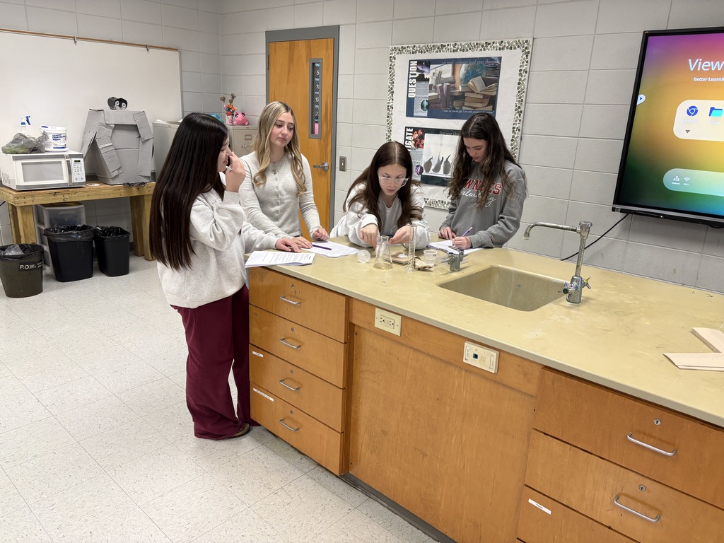 Four girls conducting an experiment